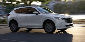 left side angle of a white 2024 Mazda CX-5 driving down a street | Vancouver, WA