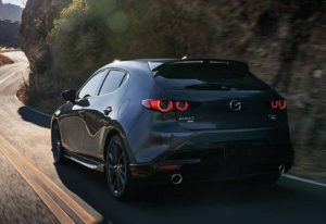 rear view of a 2024 Mazda3 Hatchback driving through a country road | Vancouver, WA