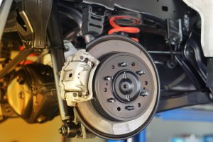 Disc brake of the vehicle for repair, in process of new tire replacement. Car brake repairing in garage. Close up. | Vancouver, WA