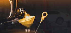 Mechanic pouring motor oil to engine with copy space on black background,Double exposure,Automobile repair shop business concept | Vancouver, WA