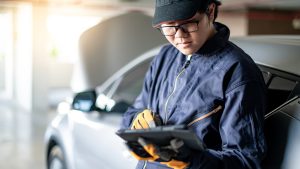 Asian Mechanic holding a tablet in a service garage | Vancouver, WA