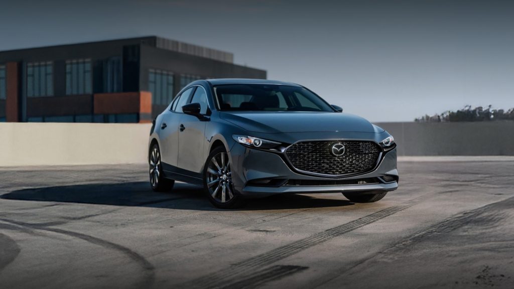Dark gray Mazda 3 sedan parked on a rooftop lot