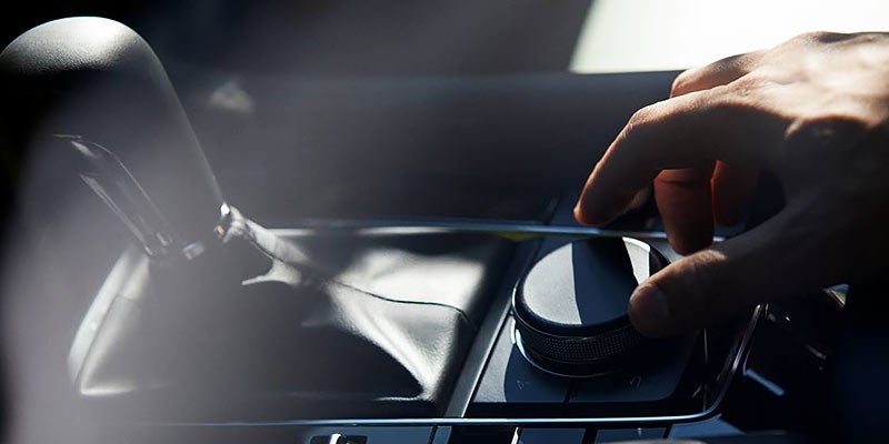 sunlit transmission and dial in the interior or a 2024 Mazda3 Sedan